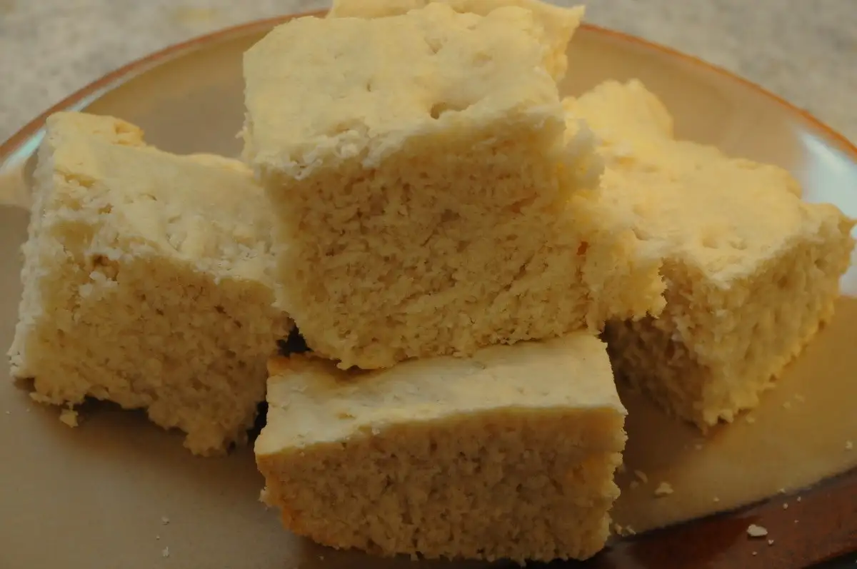 Johnny cake squares stacked warm on a plate
