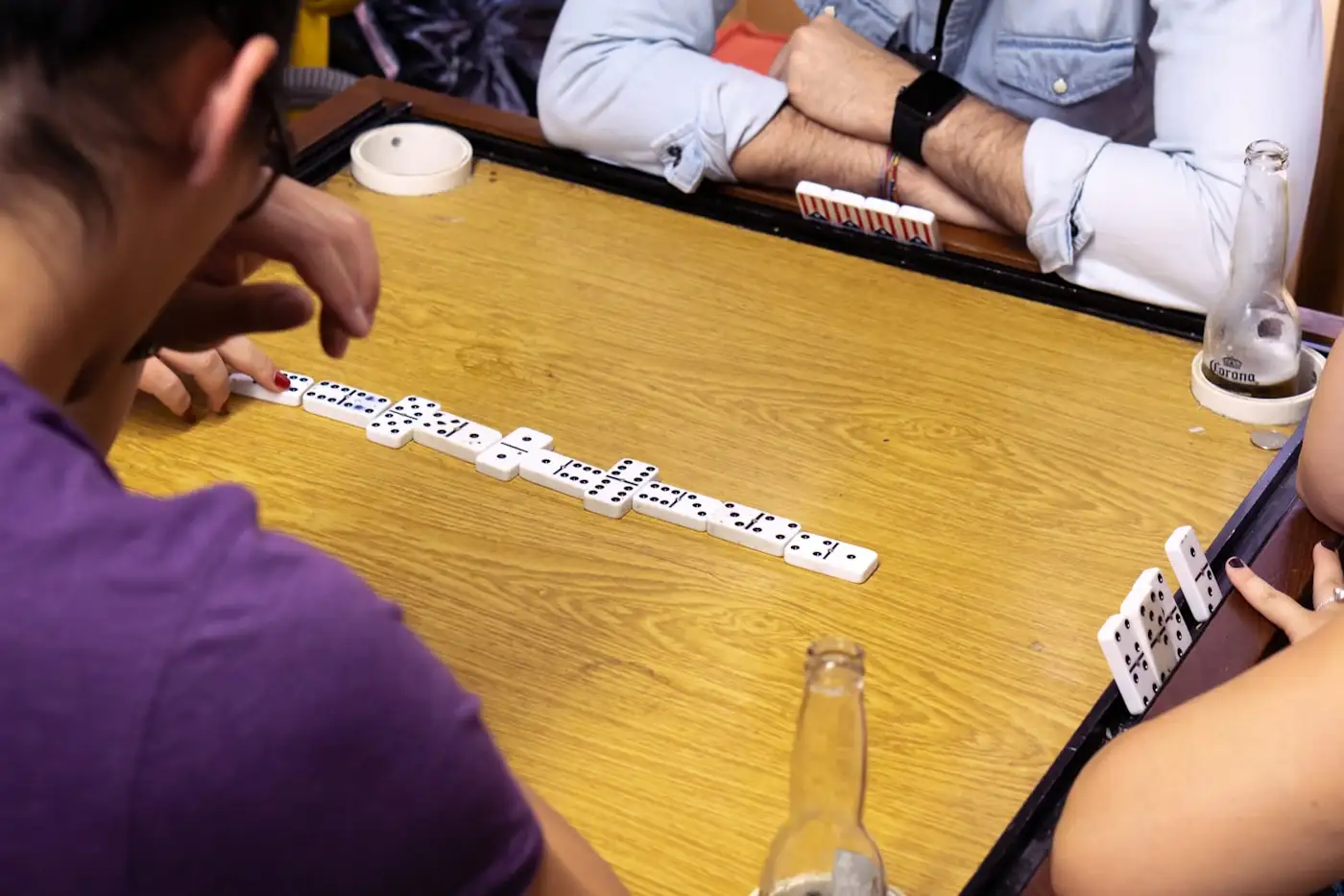 A game of dominoes mid-slam, out back